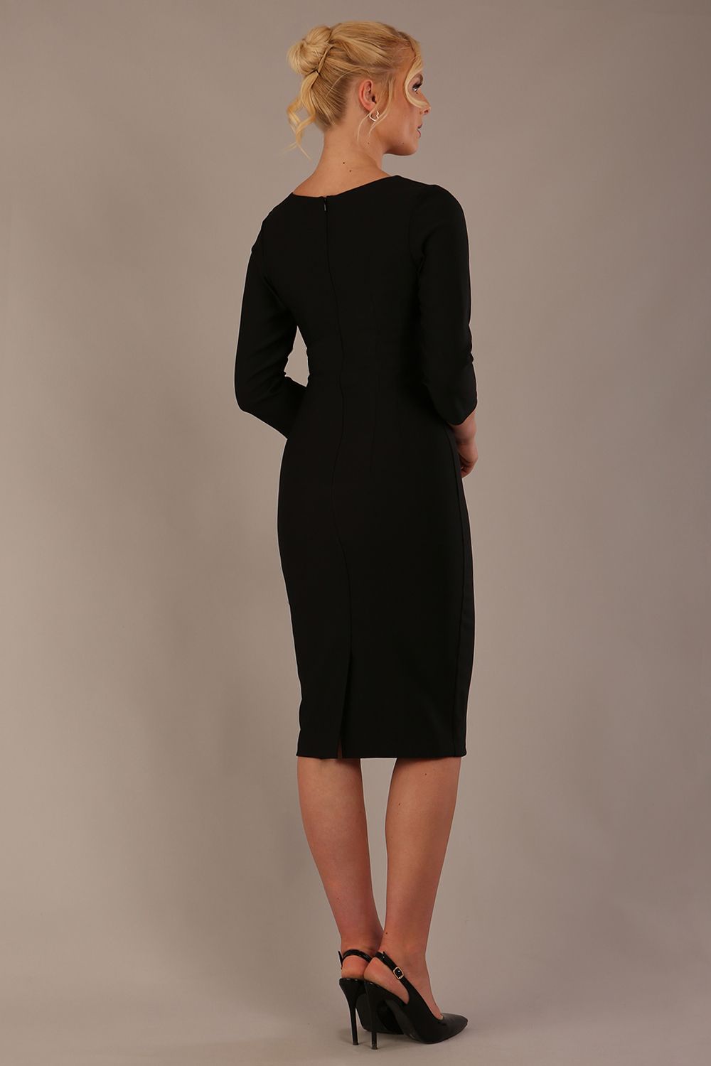 Back view of a black graduation dress with a centre zipper and hem slit