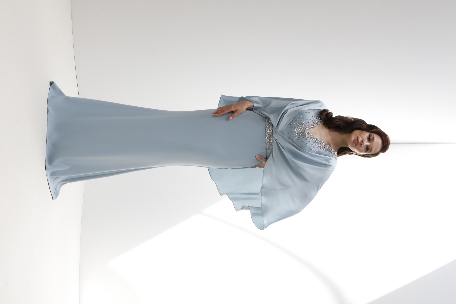 Powder blue beaded V-neck gown with chiffon cape sleeves and crystal belt