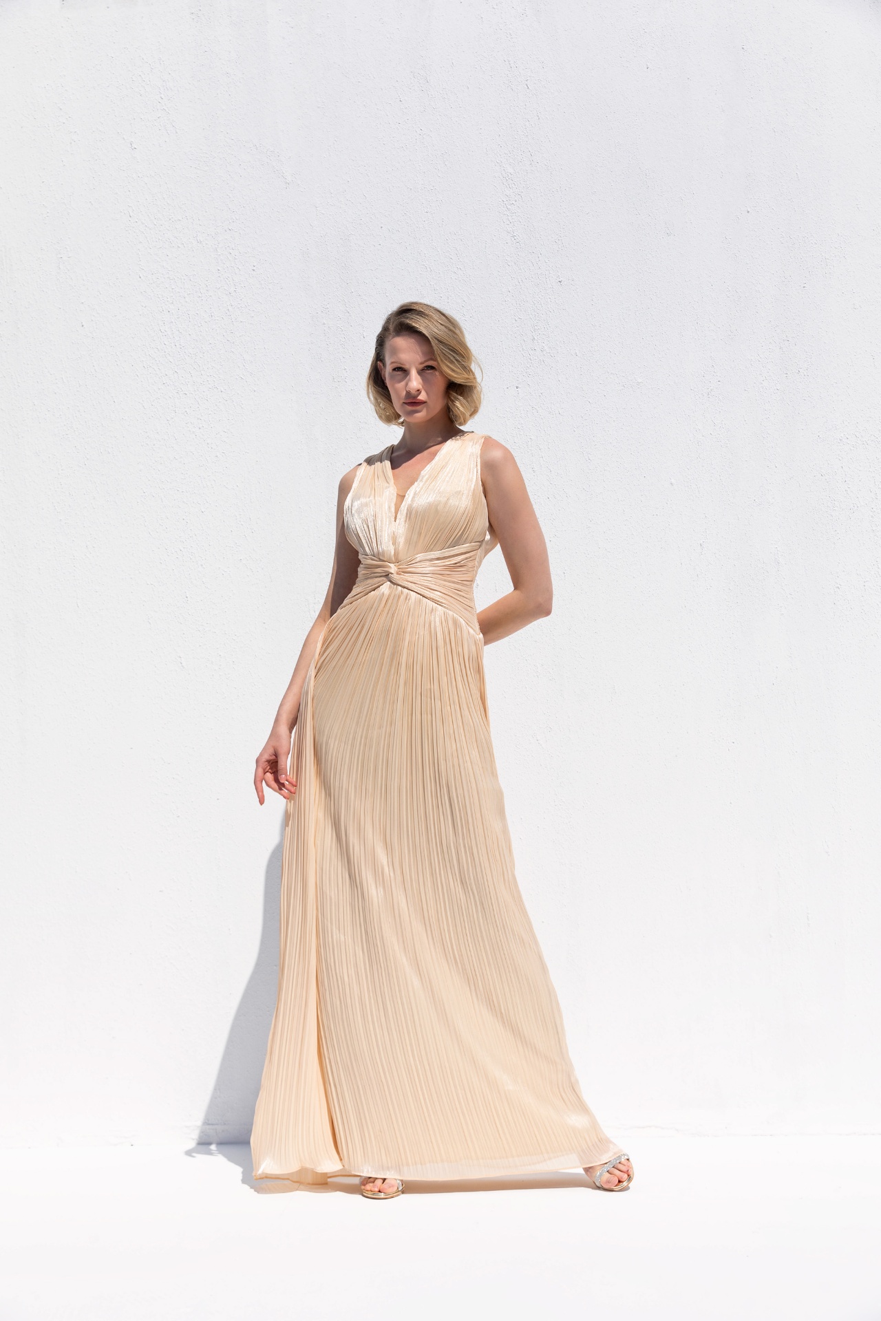 Champagne pleated satin V-neck gown with knotted waist