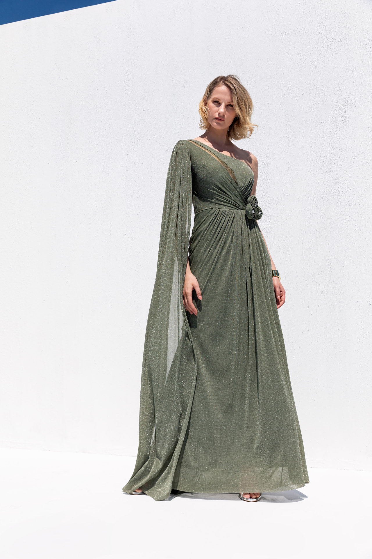 Sage shimmer one-shoulder gown with cape sleeve and rosette waist