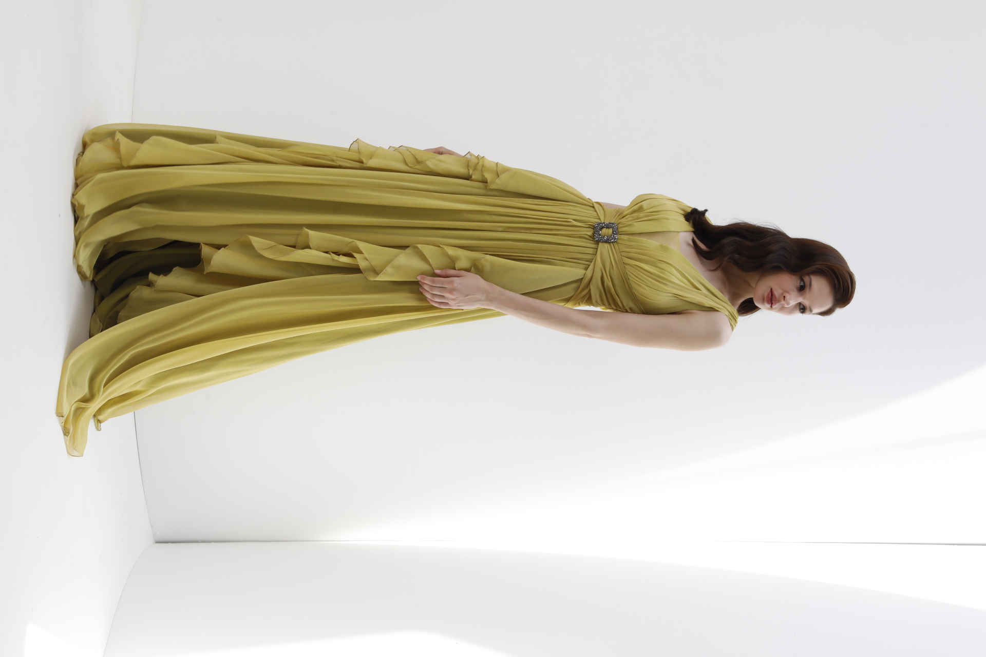 Chartreuse silk chiffon gown with crystal buckle and cascading ruffles